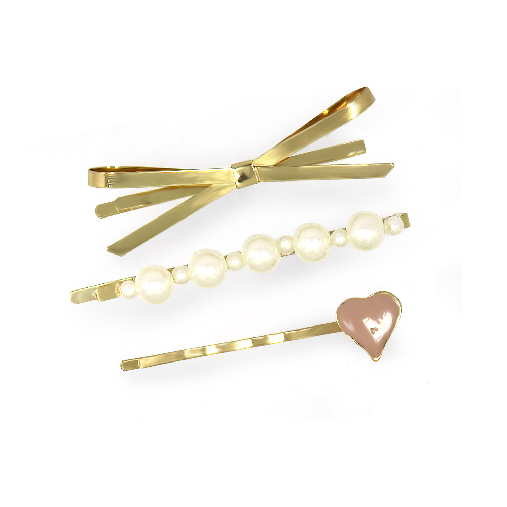 A collection of three distinct gold hair clips including a bow, pearl, and heart design
