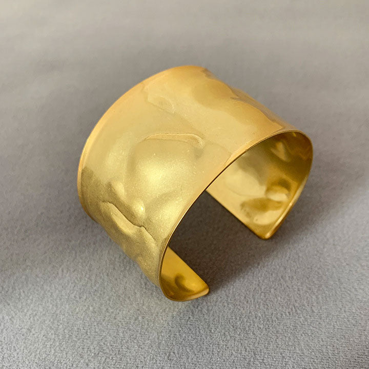 Detailed view of the gold hammered cuff bracelet's texture