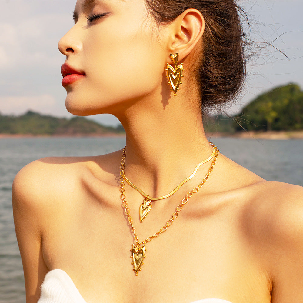 A woman wearing the waterproof gold heart earrings, demonstrating their stylish appeal for any occasion.