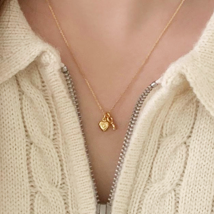 Model wearing the gold 925 sterling silver heart key necklace.