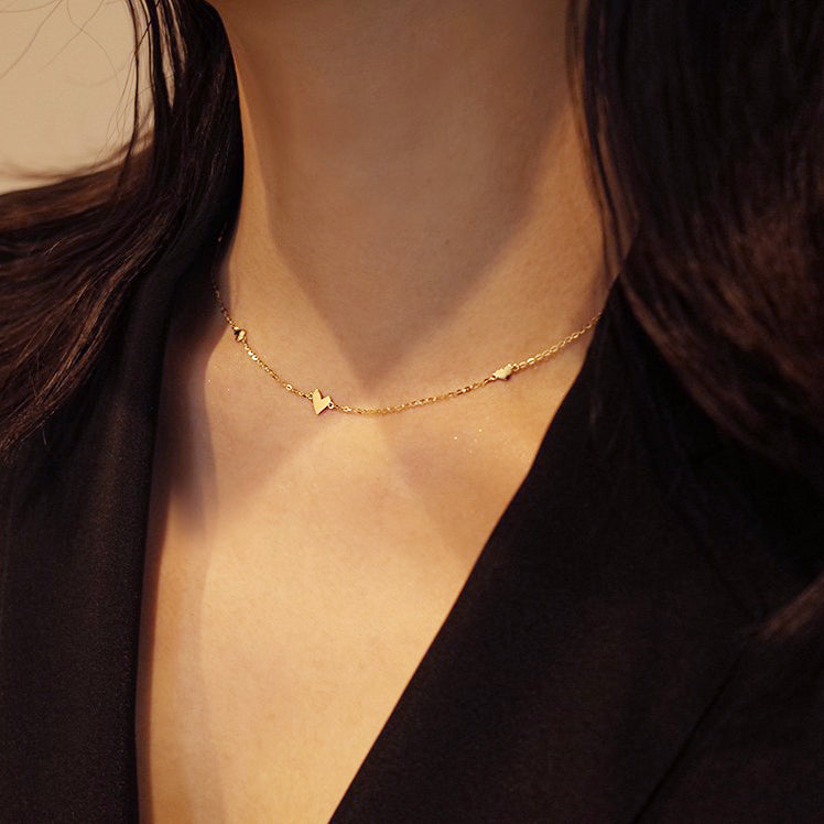 A model showcasing the elegant S925 Sterling Silver Triple Heart Necklace in gold.