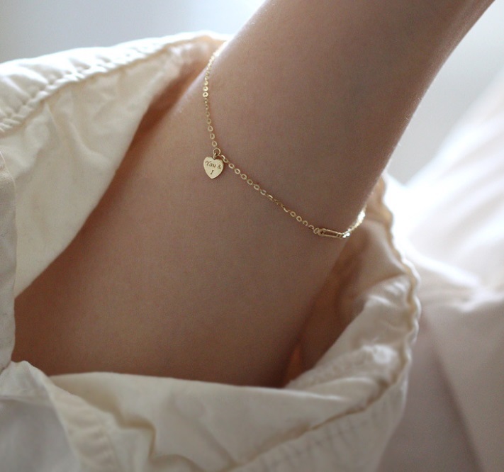 A detailed view of the 925 Sterling Silver Heart Gold Plated Bracelet's clasp and chain.