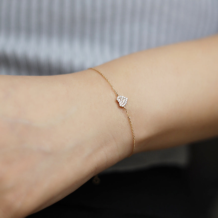 Model wearing the 925 Sterling Silver Gold Pave CZ Heart Bracelet to show its fit and style.