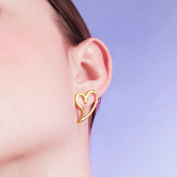 Model showcasing the stainless steel gold hollow heart stud earring.