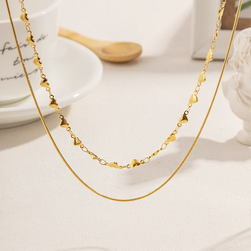 Detailed view of the gold double-layered heart chain necklace