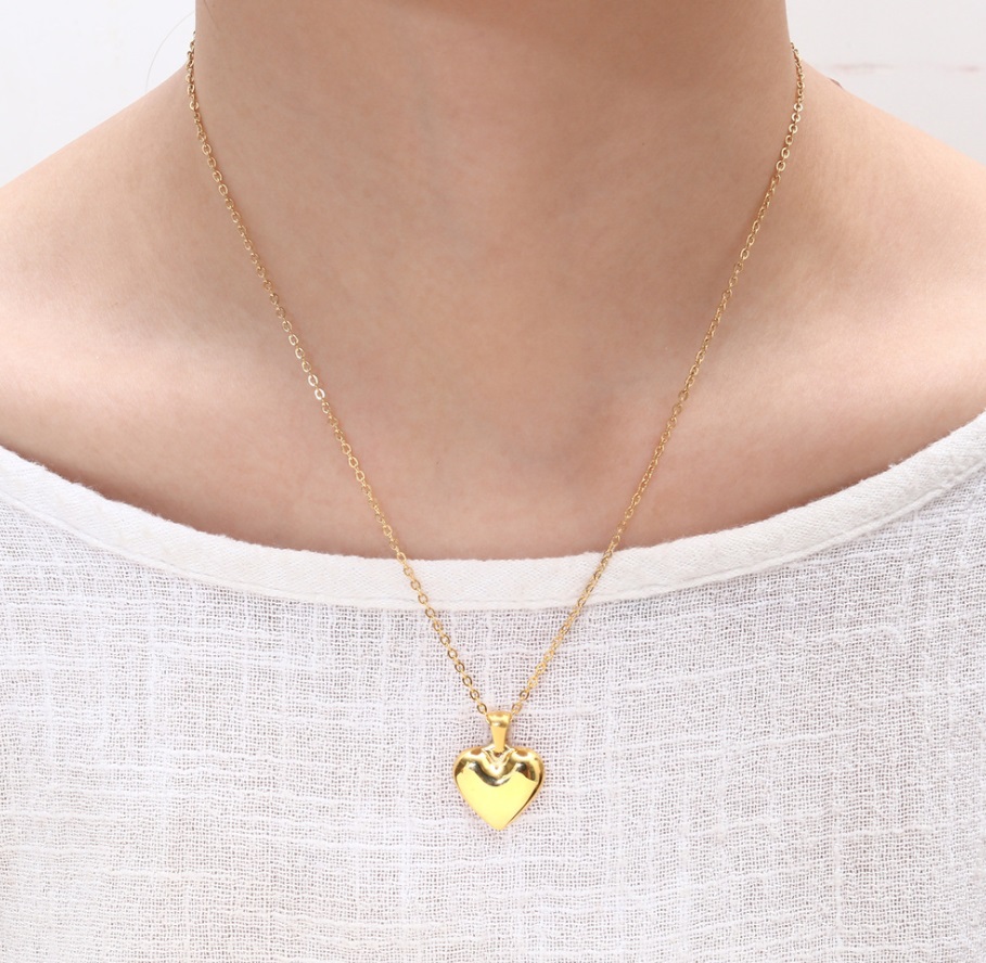 Model showcasing the gold heart pendant necklace