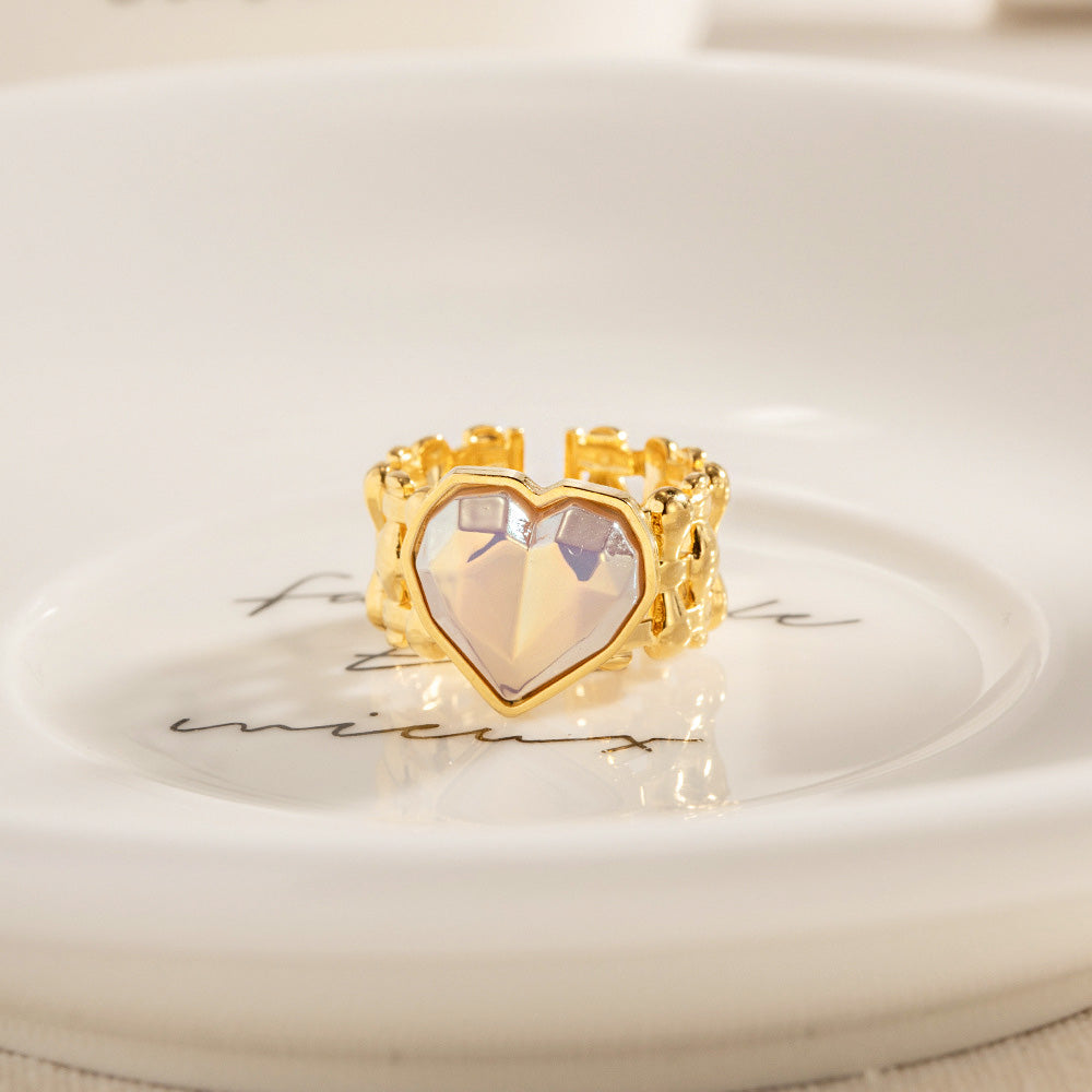 A detailed view of the gold-finished wide weave band on the mermaid heart stone ring.