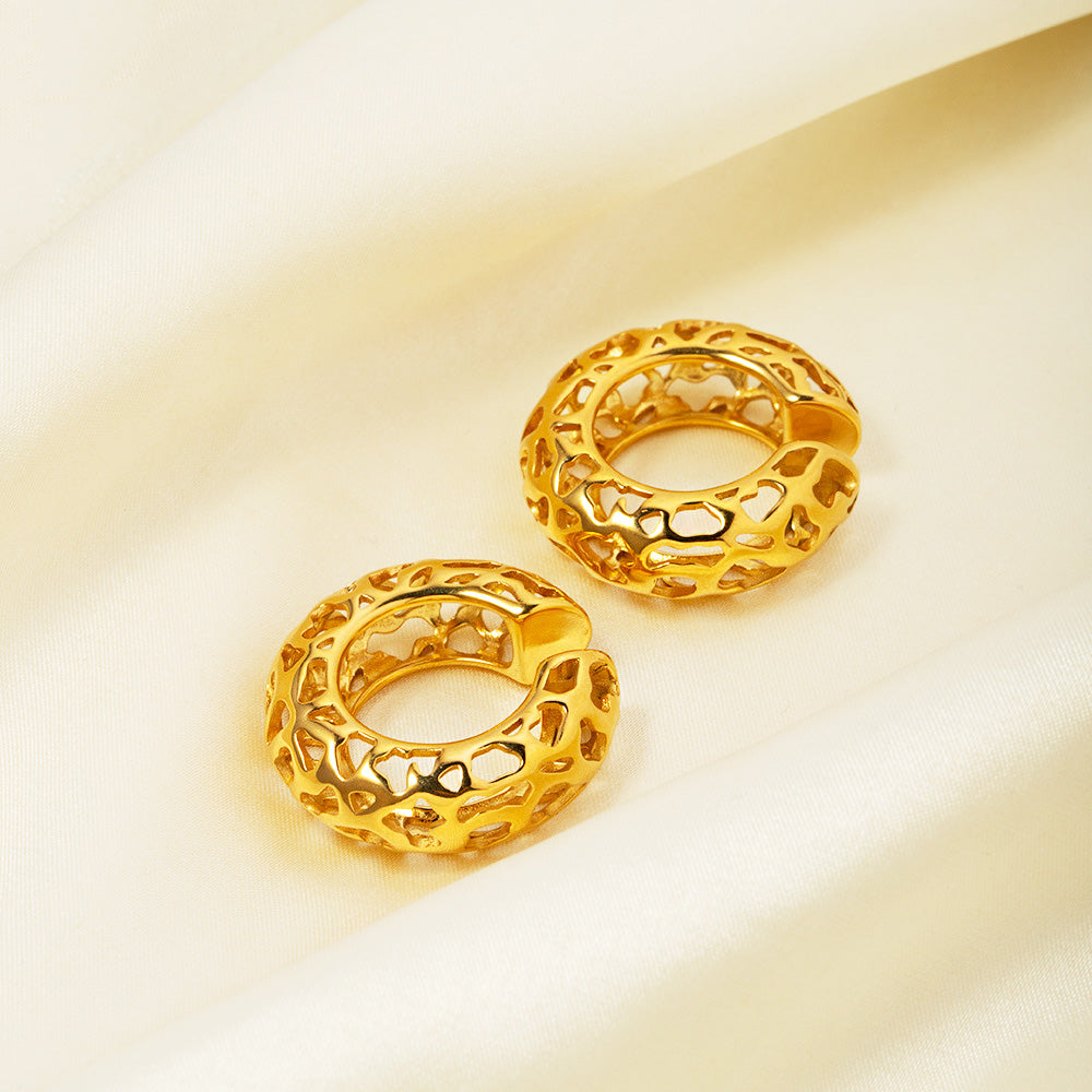 Detailed view of the intricate hollow design on the gold-plated ear cuffs