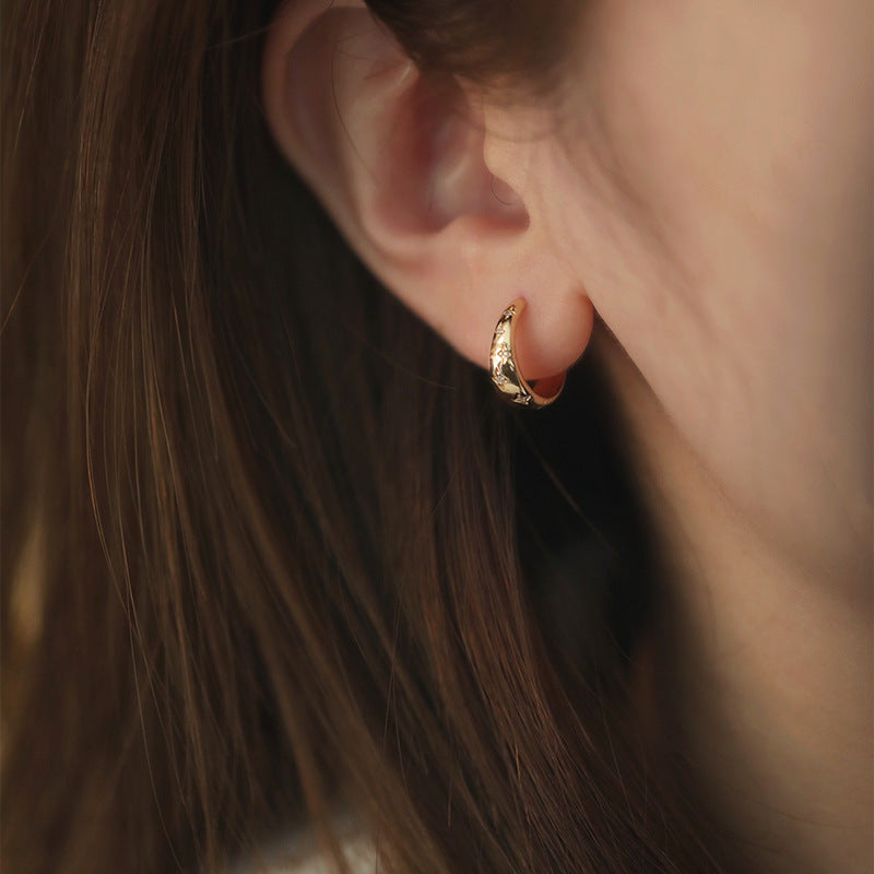 Model wearing the gold star zirconia hoop earring