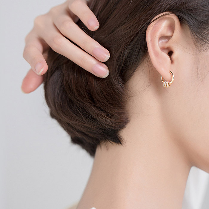 Model showcasing the Open Circle Earring to display its size and style when worn.