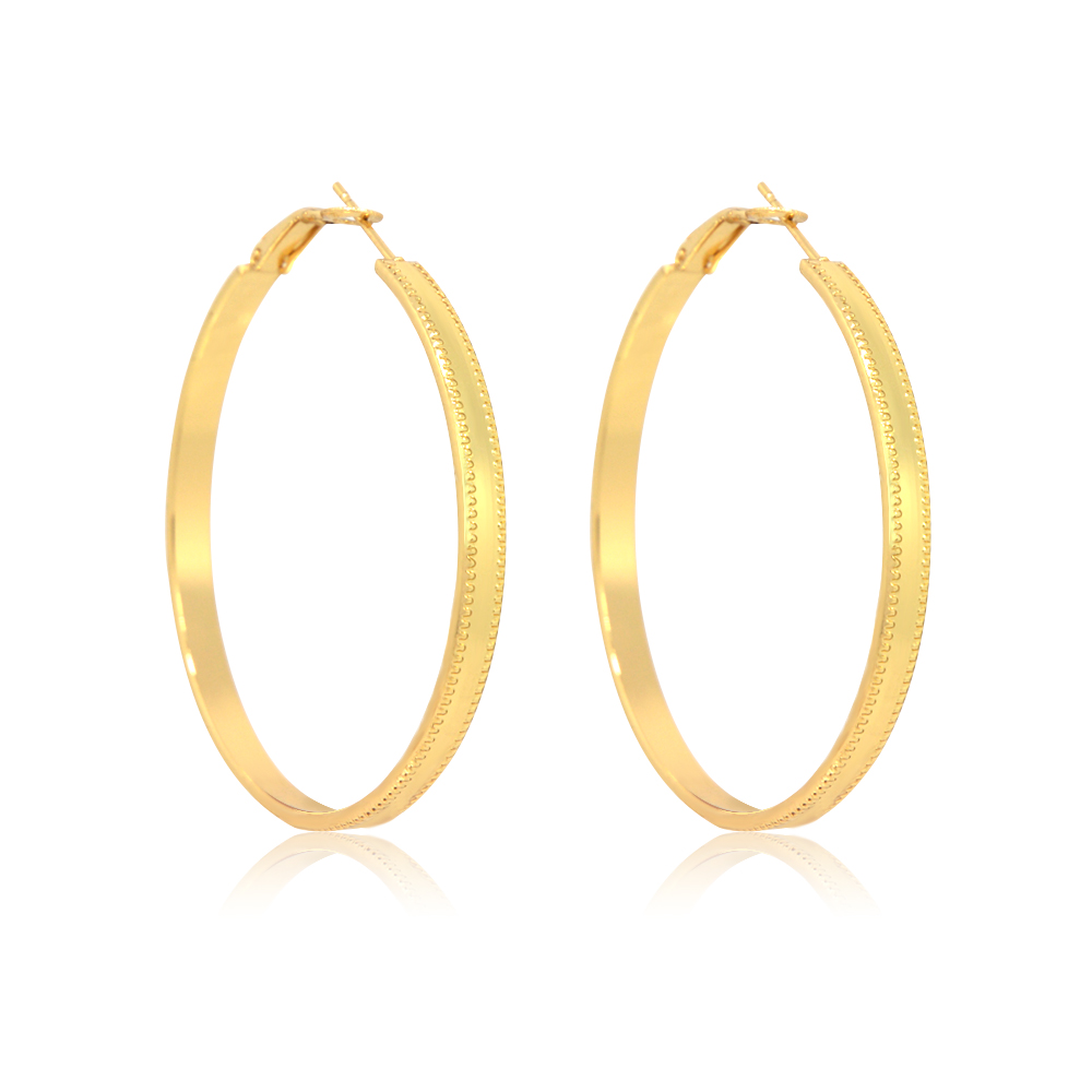 Detailed view of the gold hoop earring's texture and closure