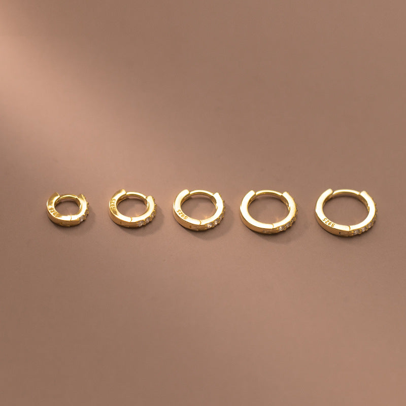 Collection of gold-plated sterling silver zircon huggie hoops in multiple sizes
