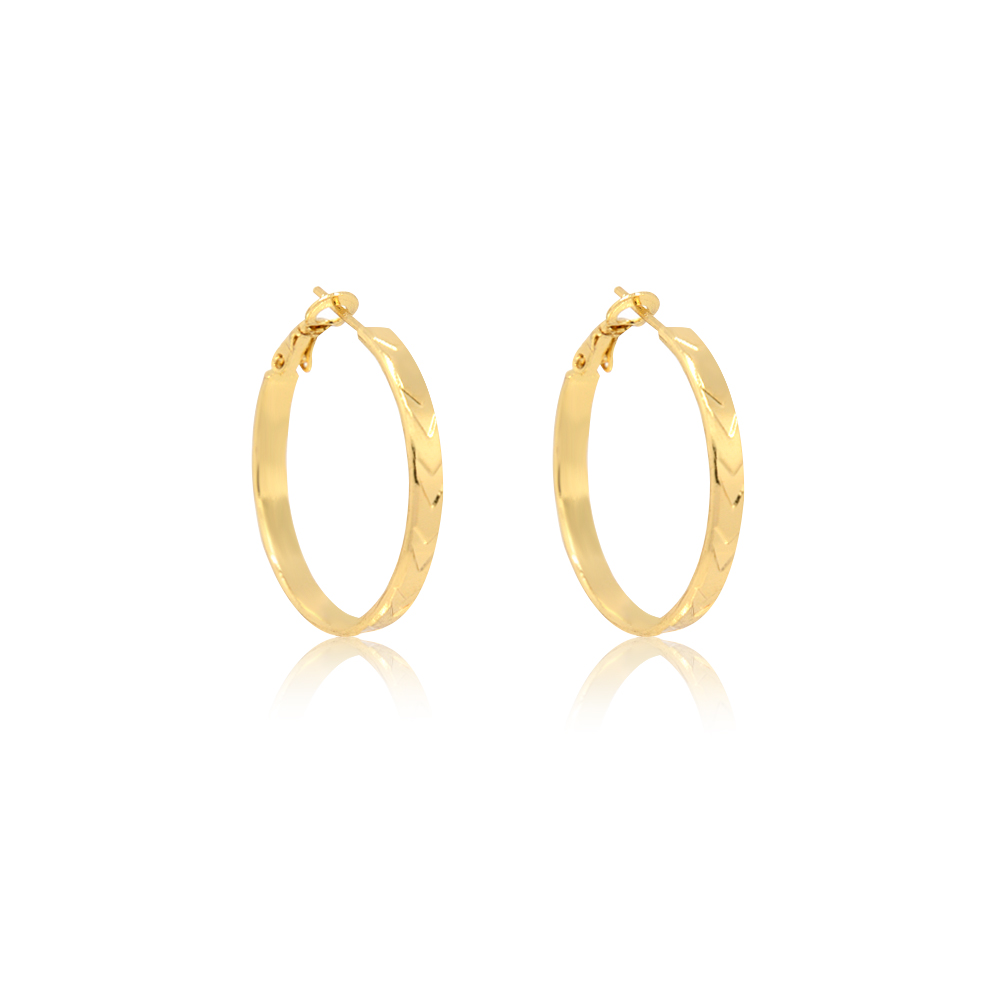 Detailed view of the textured exterior on the gold hoop earrings
