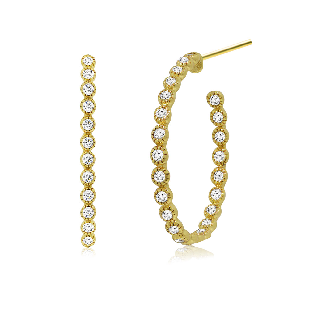 A pair of bezel set gold plated hoop earrings shown at an angle.