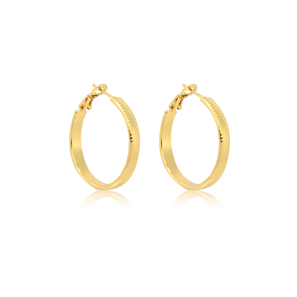 Detailed view of the gold hoop earrings with textured edges and secure latch closures.