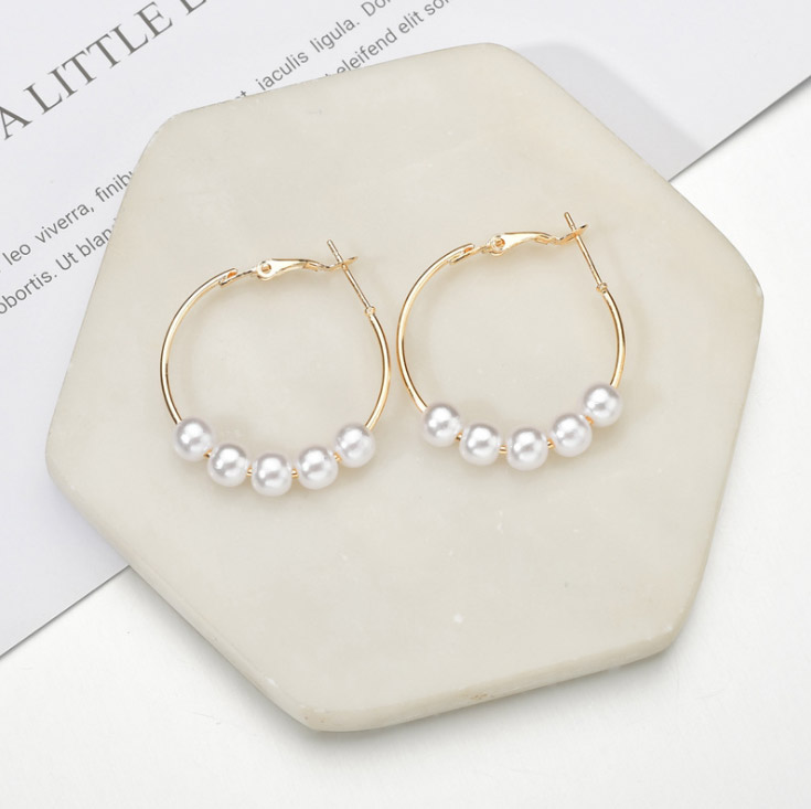 Detailed view of Pearl Hoop Earrings on a marble surface