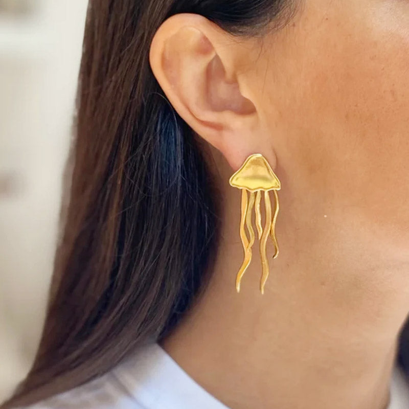 Model wearing the gold stainless steel jellyfish stud earring