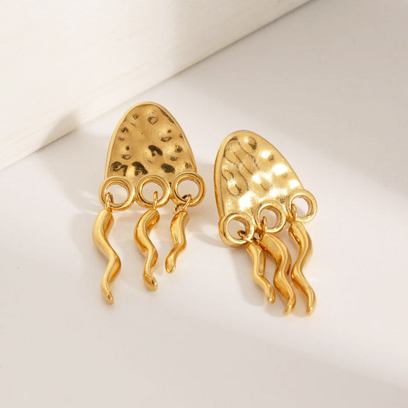 Close-up of the gold jellyfish earrings with detailed tentacles