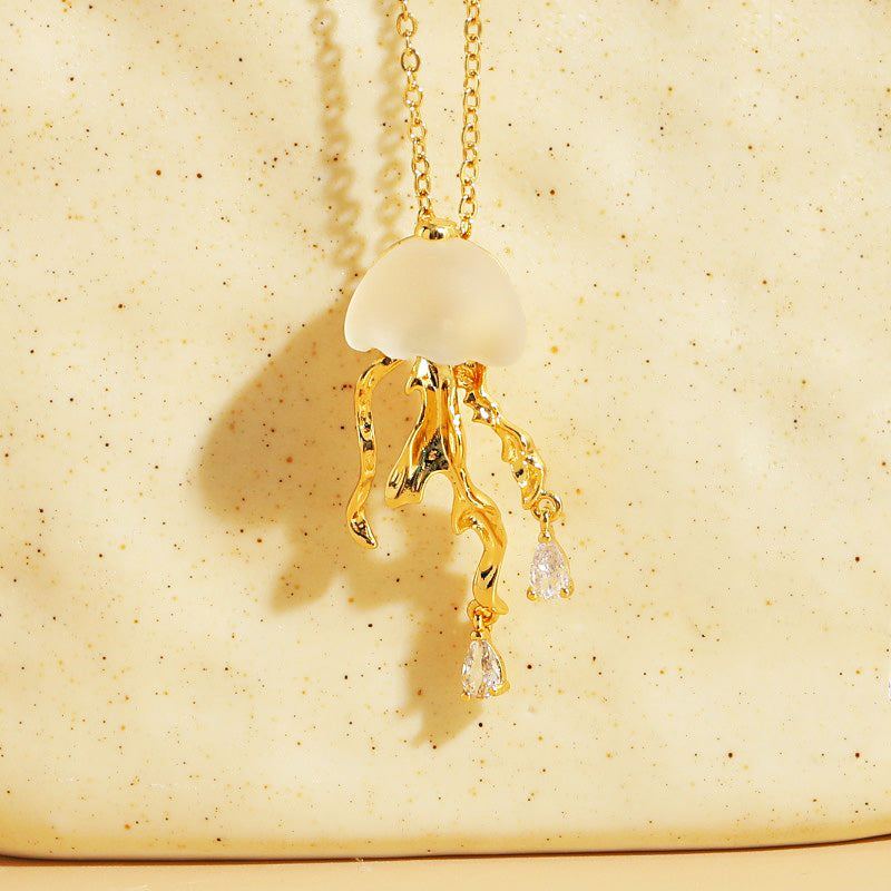 Detailed view of the gold jellyfish necklace with sparkling crystal tentacles