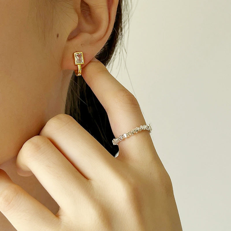Model showcasing the vintage-style gold zircon earrings with a matching bracelet.