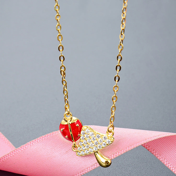 Gold-plated sterling silver necklace with a detailed ladybug and leaf pendant