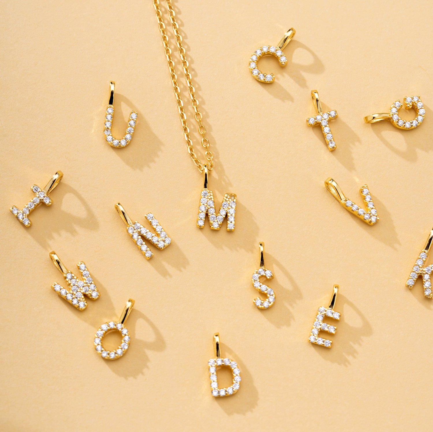 Gold and silver alphabet pendants with zircon stones