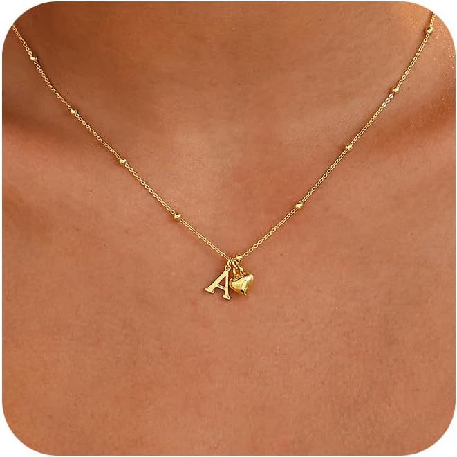 A model showcasing the 14K gold plated heart initial necklace.