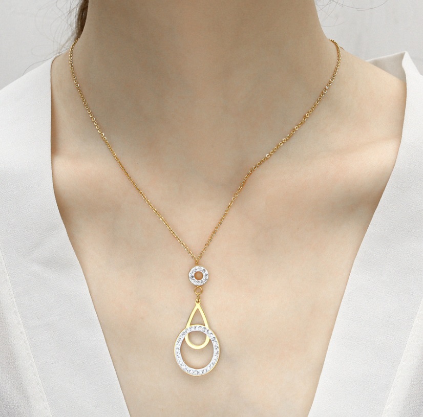 Detailed view of the gold necklace pendant with crystals