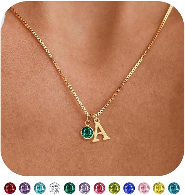 A close-up of the customizable gold initial necklace with a colored gemstone.