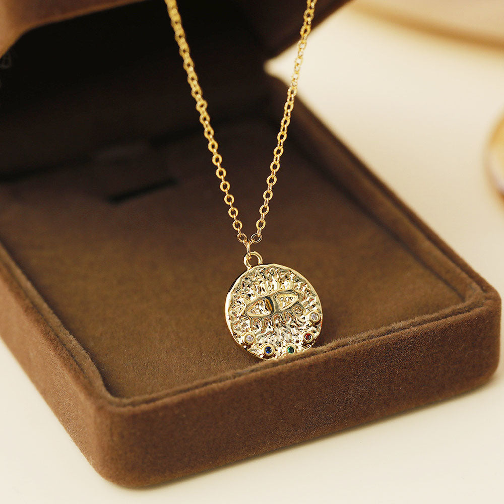 Evil eye pendant necklace with colorful gemstones displayed in a luxurious brown velvet box.