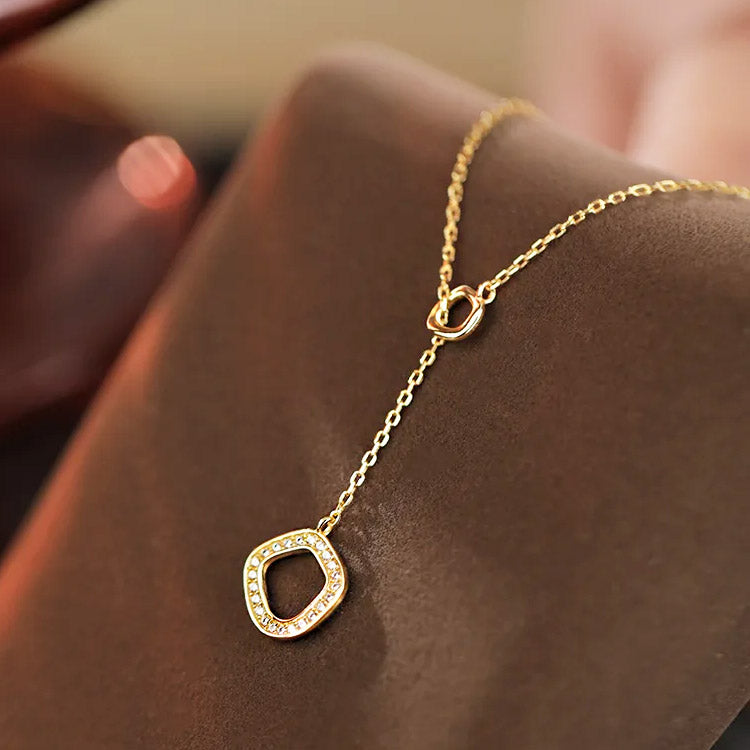 A detailed studio shot of the 925 sterling silver geometric necklace in a gold finish.