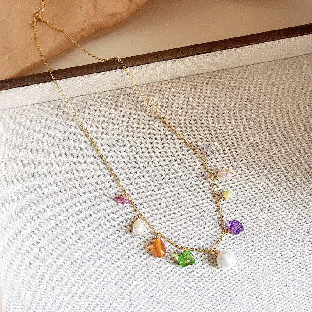 Full view of the gold necklace with multicolored gemstones