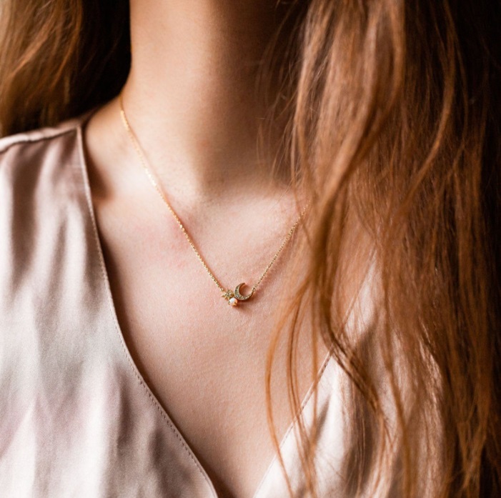 A model wearing the Moon and Star Gold Plated Necklace