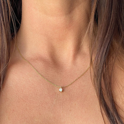 Model showcasing the delicate 4mm opal necklace