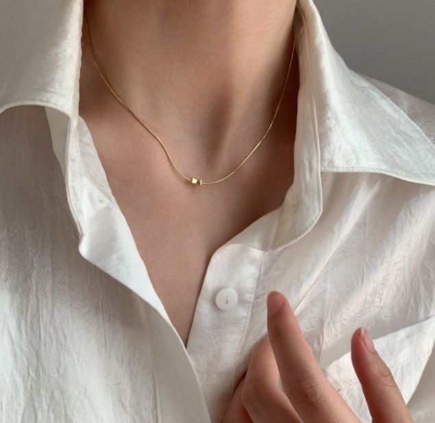 A close-up of the 925 Sterling Silver Chain Necklace with a square pendant, worn to showcase its elegant design.