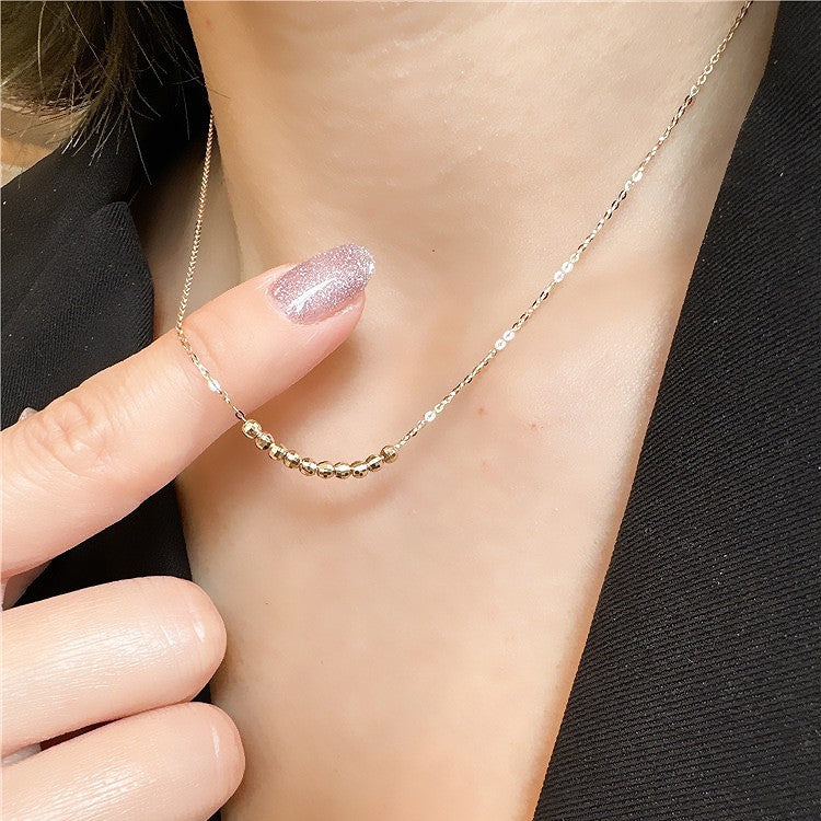 Model showcasing the 18K gold plated faceted bead necklace