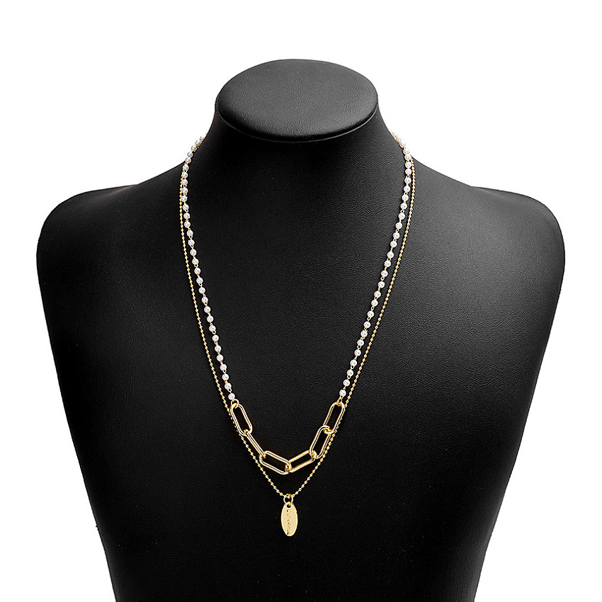 White Pearl Strand Necklace displayed on a bust