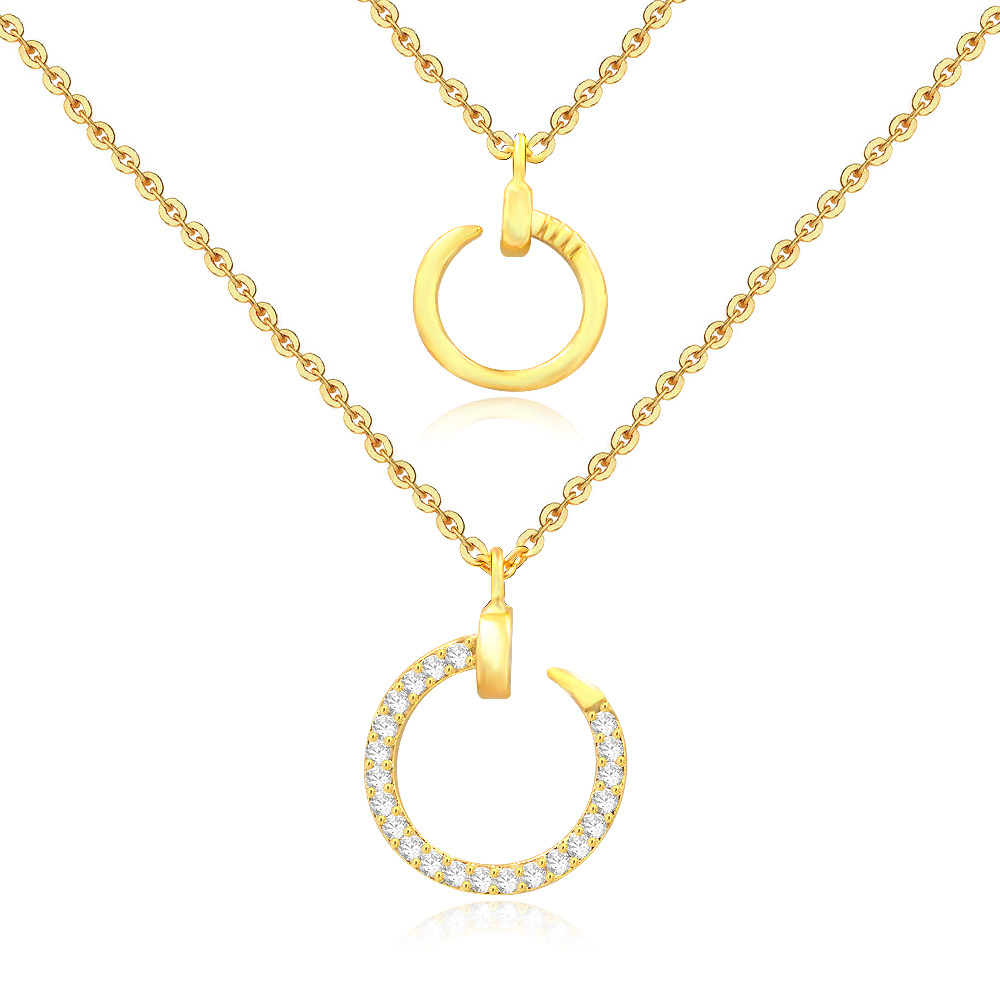 Close-up of the gold circle pendants on the layered necklace