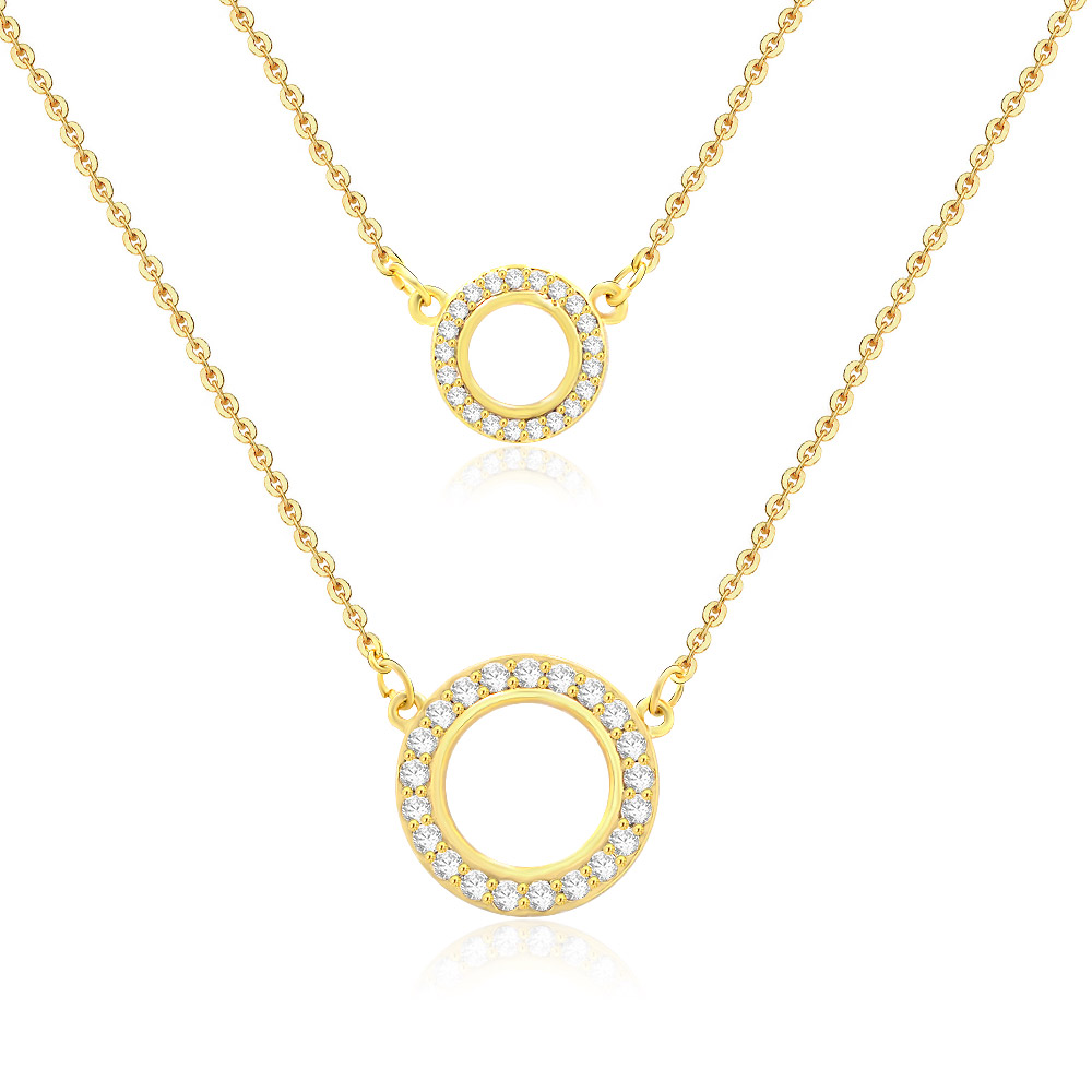 Detailed view of the gold double circle pendants with cubic zirconia stones.