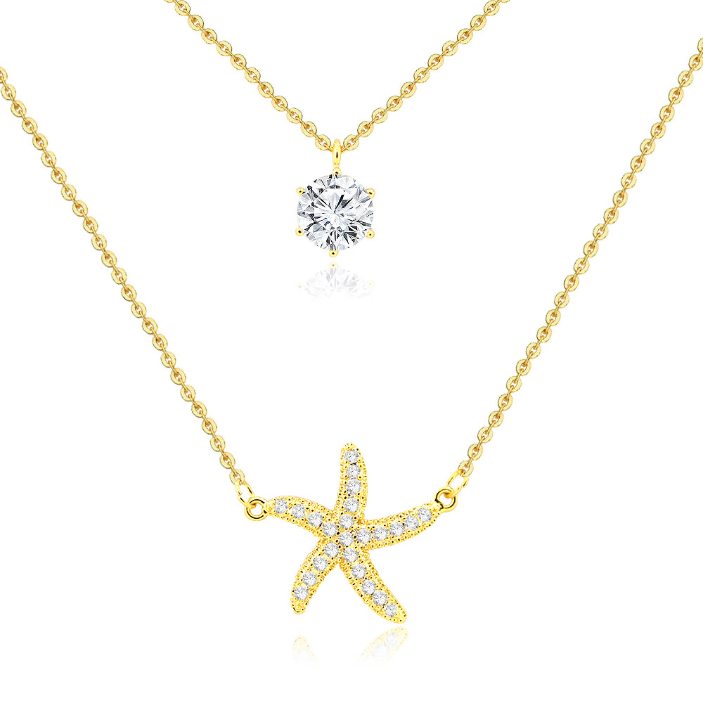 Detailed view of the starfish and solitaire pendants on the layered necklace