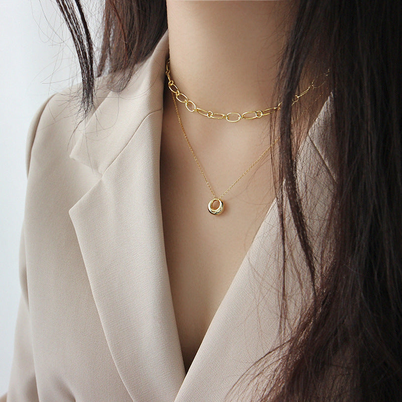 The 18K gold plated necklace shown on a model, perfect for layering.