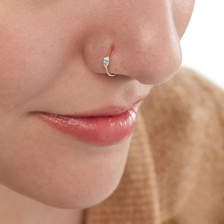 A woman wearing a stylish gold no-piercing nose cuff