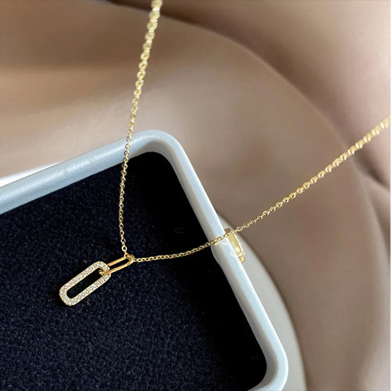 A close-up view of the gold oval pavé CZ zircon pendant, showcasing its brilliant stones and fine craftsmanship.