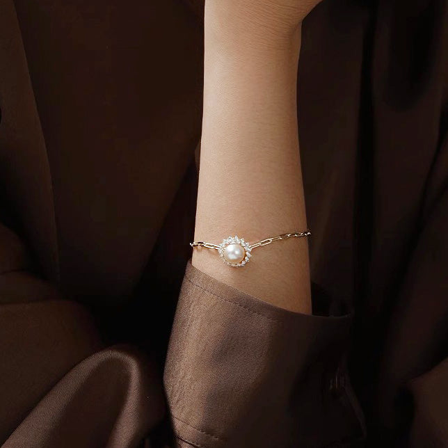 Model wearing the sterling silver pearl and zircon bracelet set to showcase its fit and style.