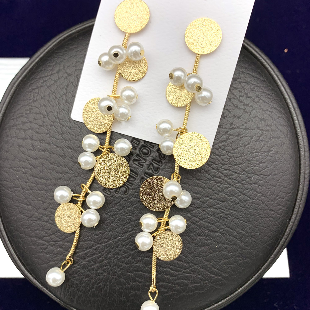Pearl Textured Disc Chain Earrings displayed on a black jewelry case