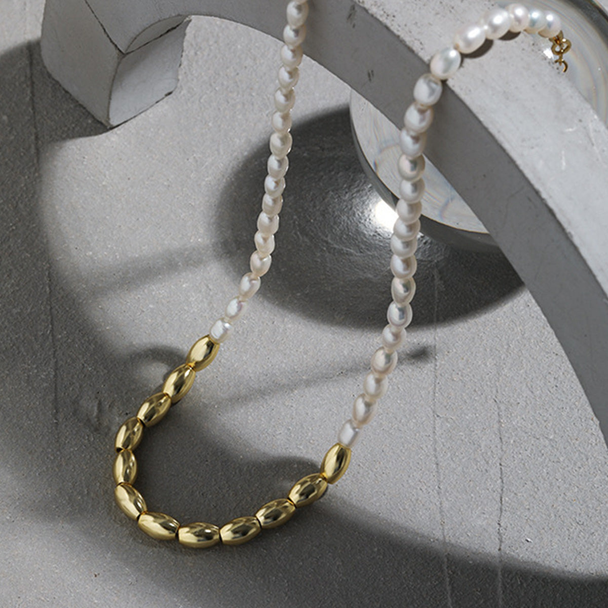 Model showcasing the elegant 18K gold PVD plated freshwater rice pearl necklace