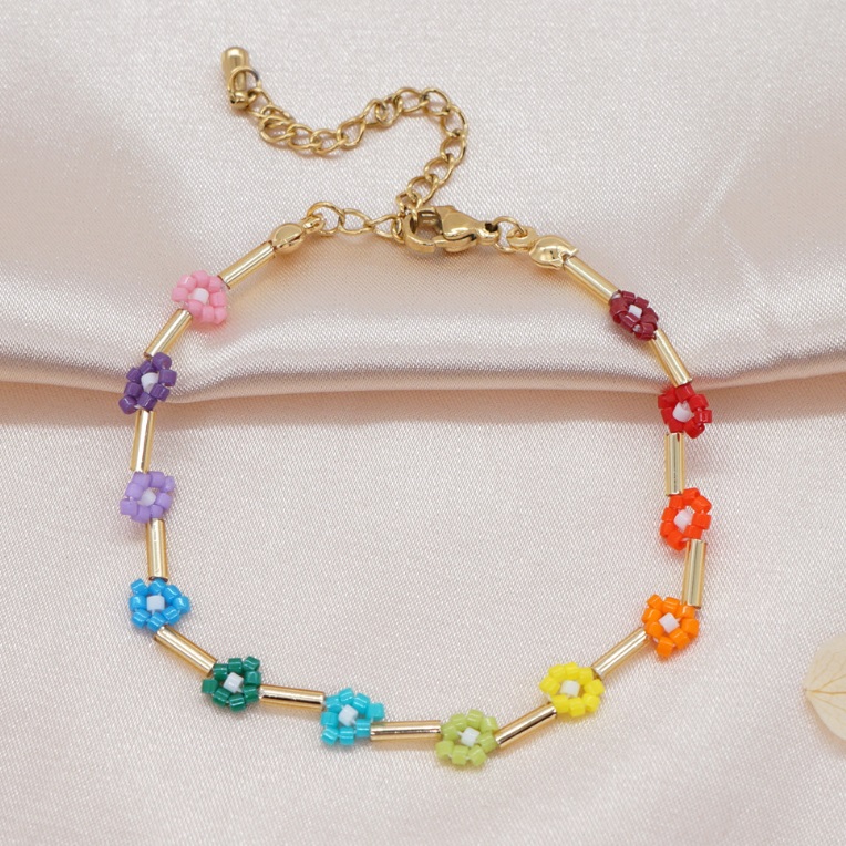 A gold-plated bracelet with colorful flower beads in a rainbow pattern