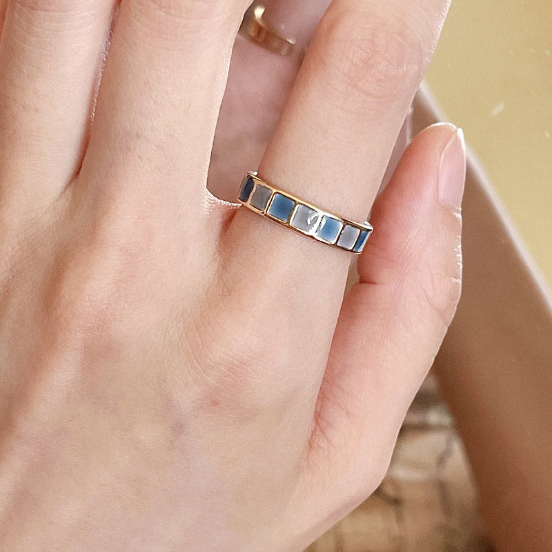 A model wearing one of the gold-plated enamel rings to showcase its style.