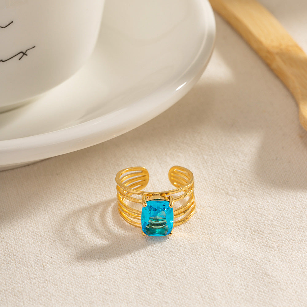 A clear view of the modern, multi-layered band of the adjustable gold ring.