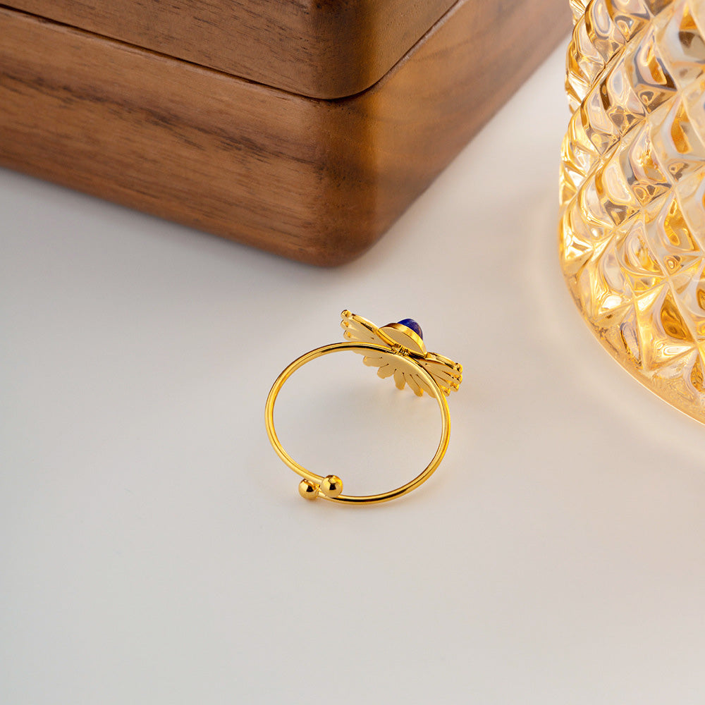 Detailed product shot of the stainless steel sunburst ring with blue gemstone